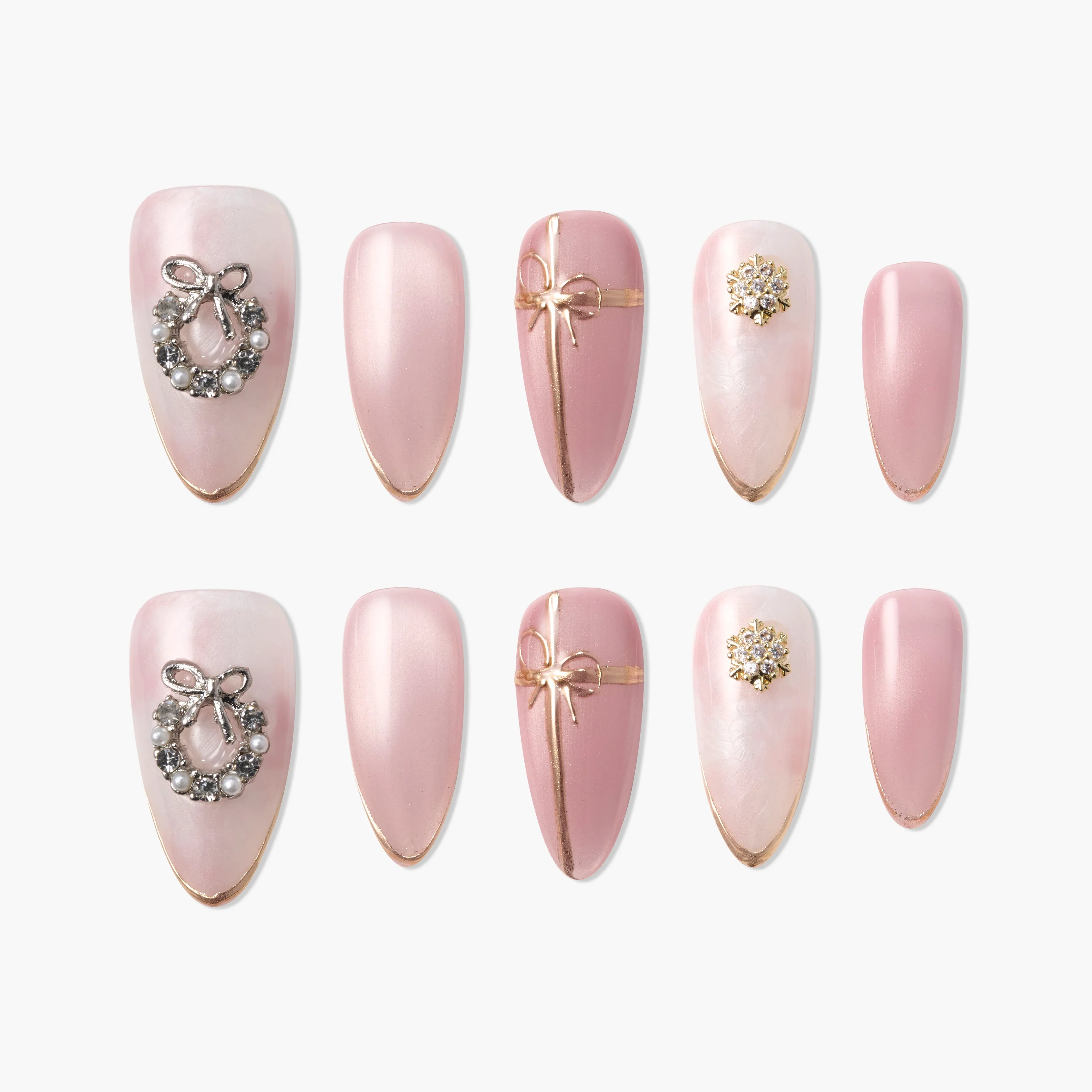 Set of pink press-on nails with gold accents, bow, wreath, and pearl decorations.