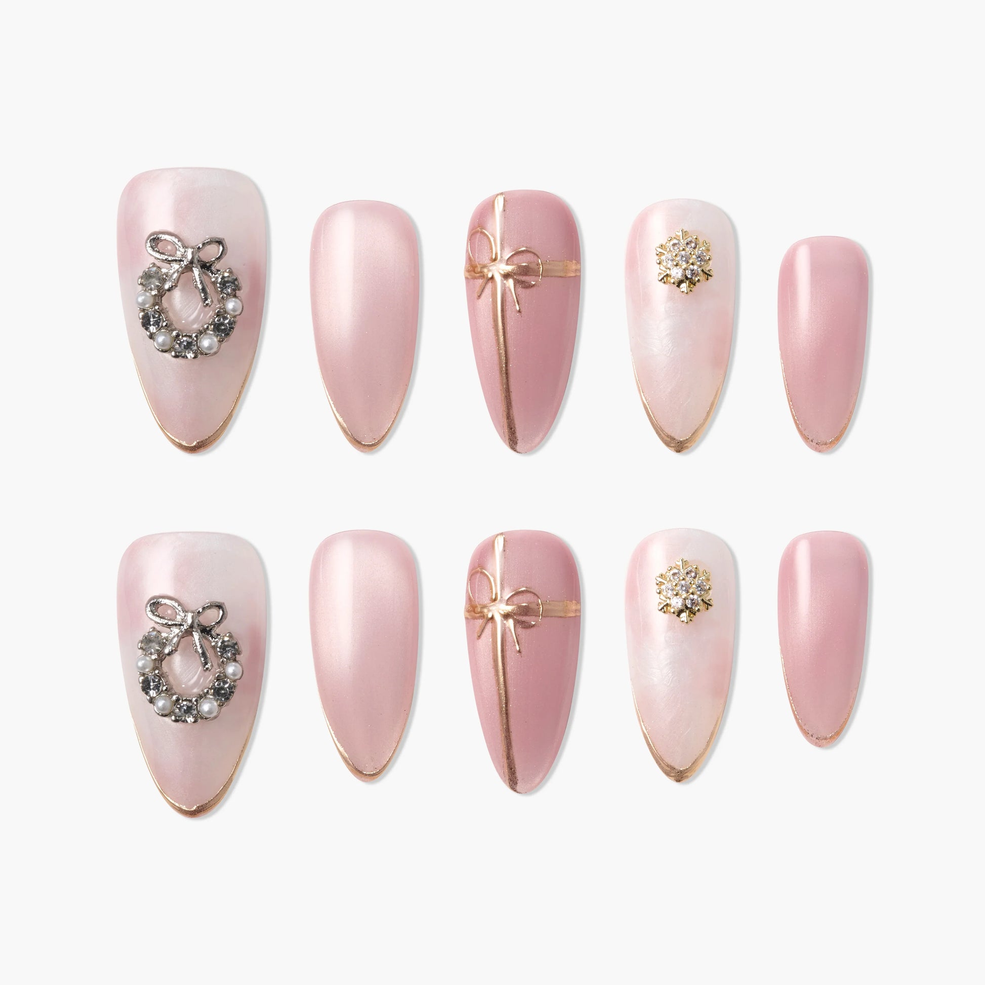 Set of pink press-on nails with gold accents, bow, wreath, and pearl decorations.