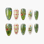 Christmas press-on nails with green glitter, snowflakes, hearts, and 3D tree decorations
