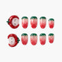Strawberry-themed press-on nails with cute 3D strawberry face accents and pink ombré tips.