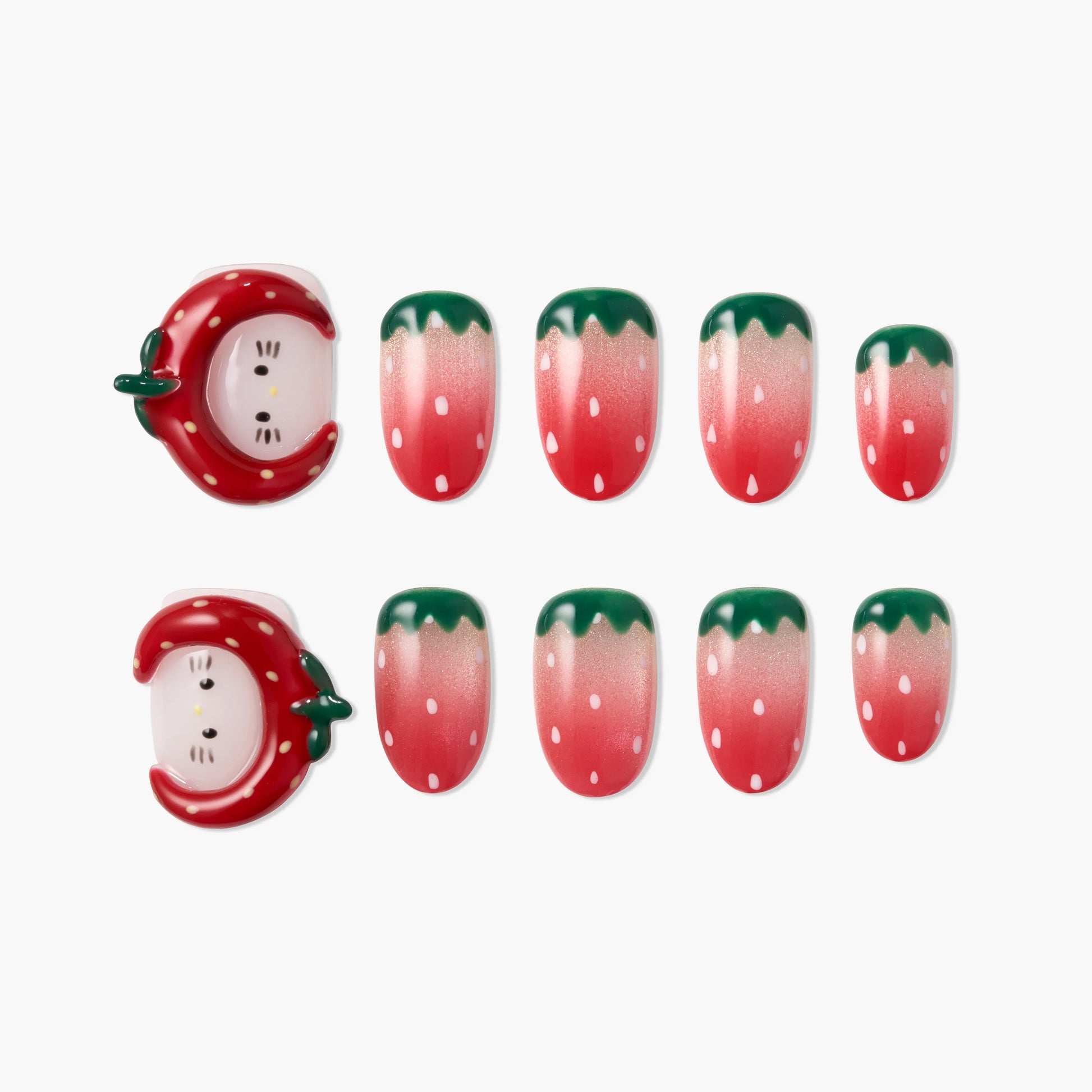 Strawberry-themed press-on nails with cute 3D strawberry face accents and pink ombré tips.