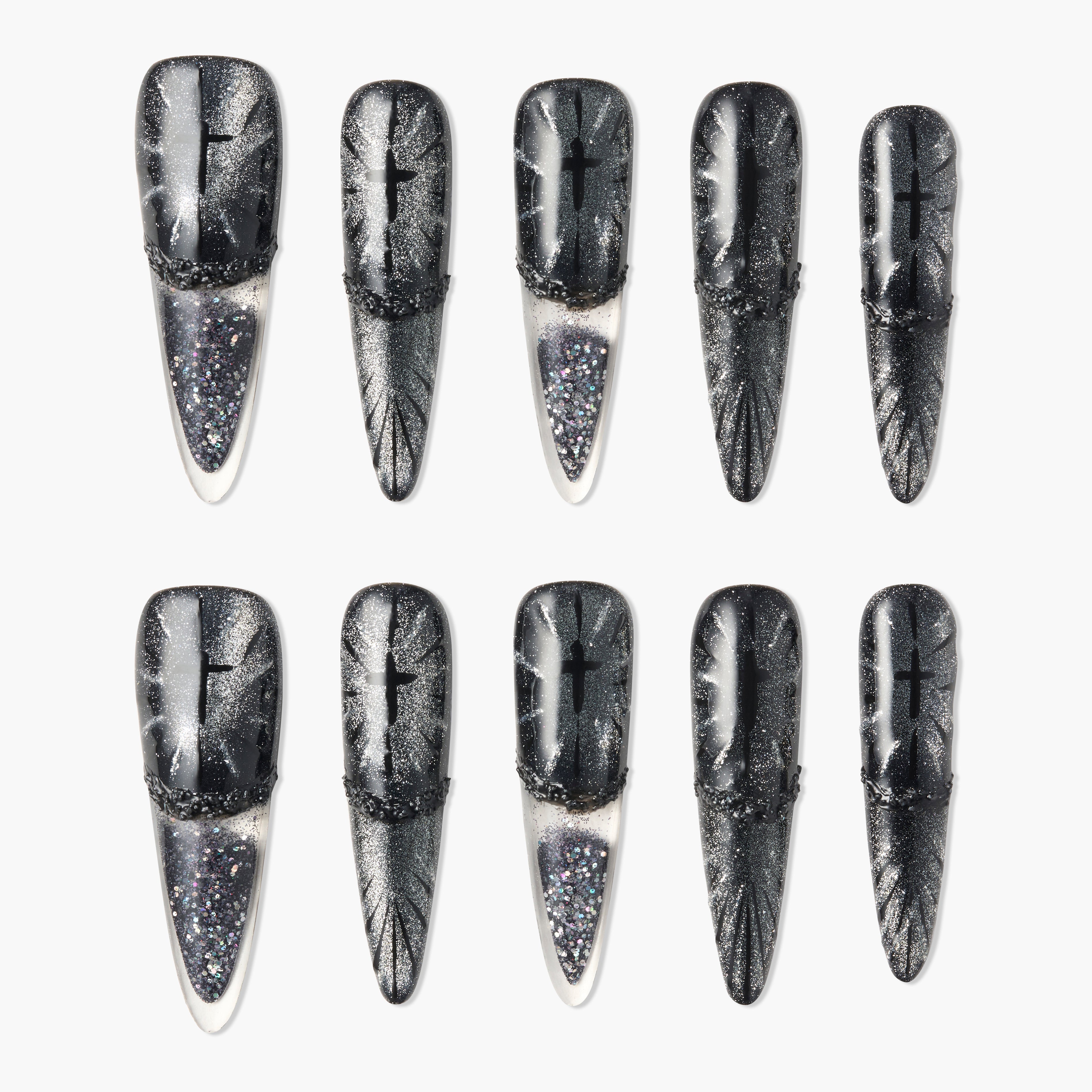 Set of black and silver glitter press-on nails with cross and starburst designs, long stiletto shape