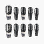 Set of black and silver glitter press-on nails with textured and ombre design on white background.