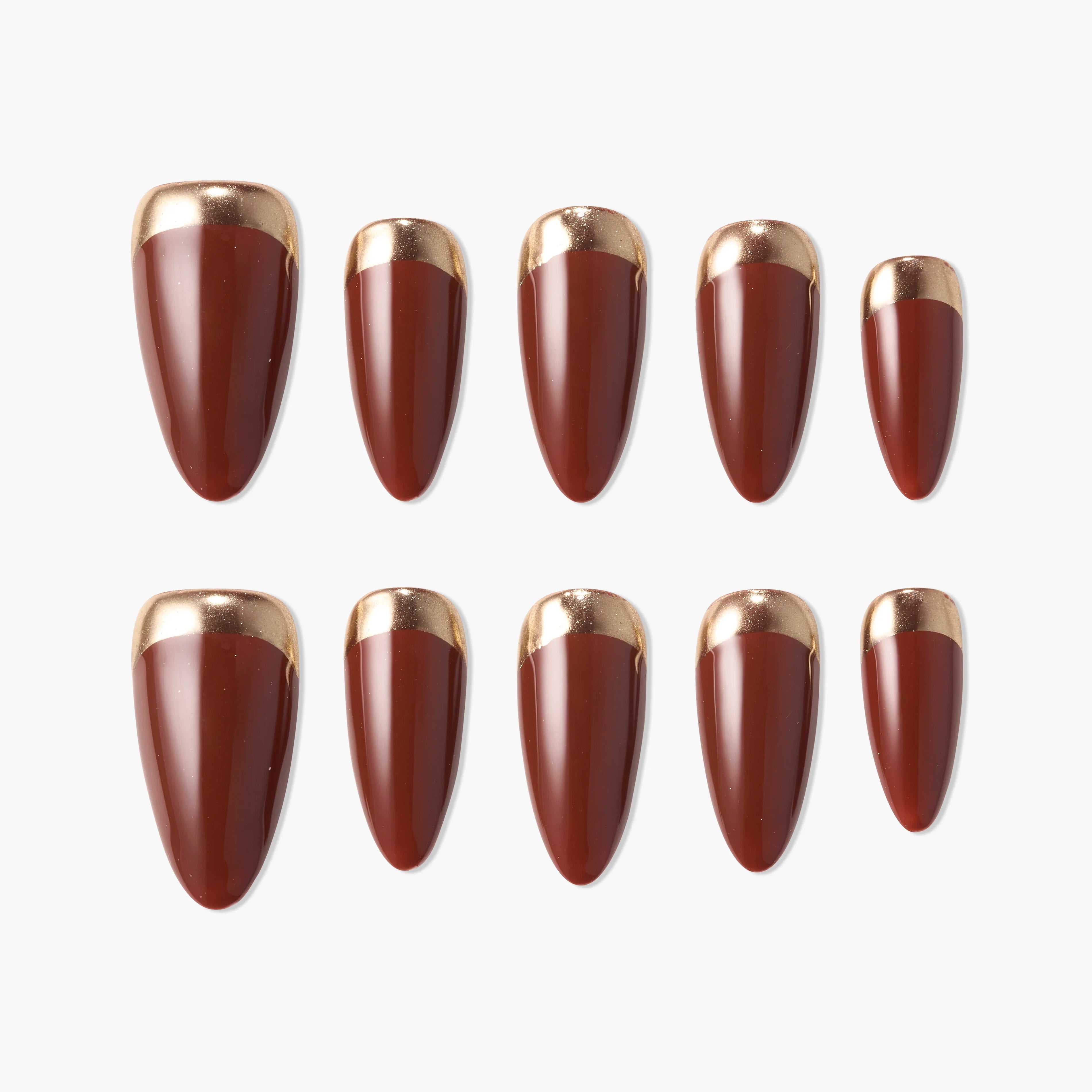 Set of glossy brown press-on nails with metallic gold tips arranged on white background