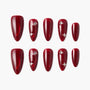 Glossy red press-on nails set with rhinestone accents on white background