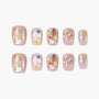 Handmade press-on nails with pink base, moon, stars, balloons, and glittery designs
