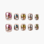 Handmade press-on nails with cartoon faces, pastel colors, and pearl accents on a white background.