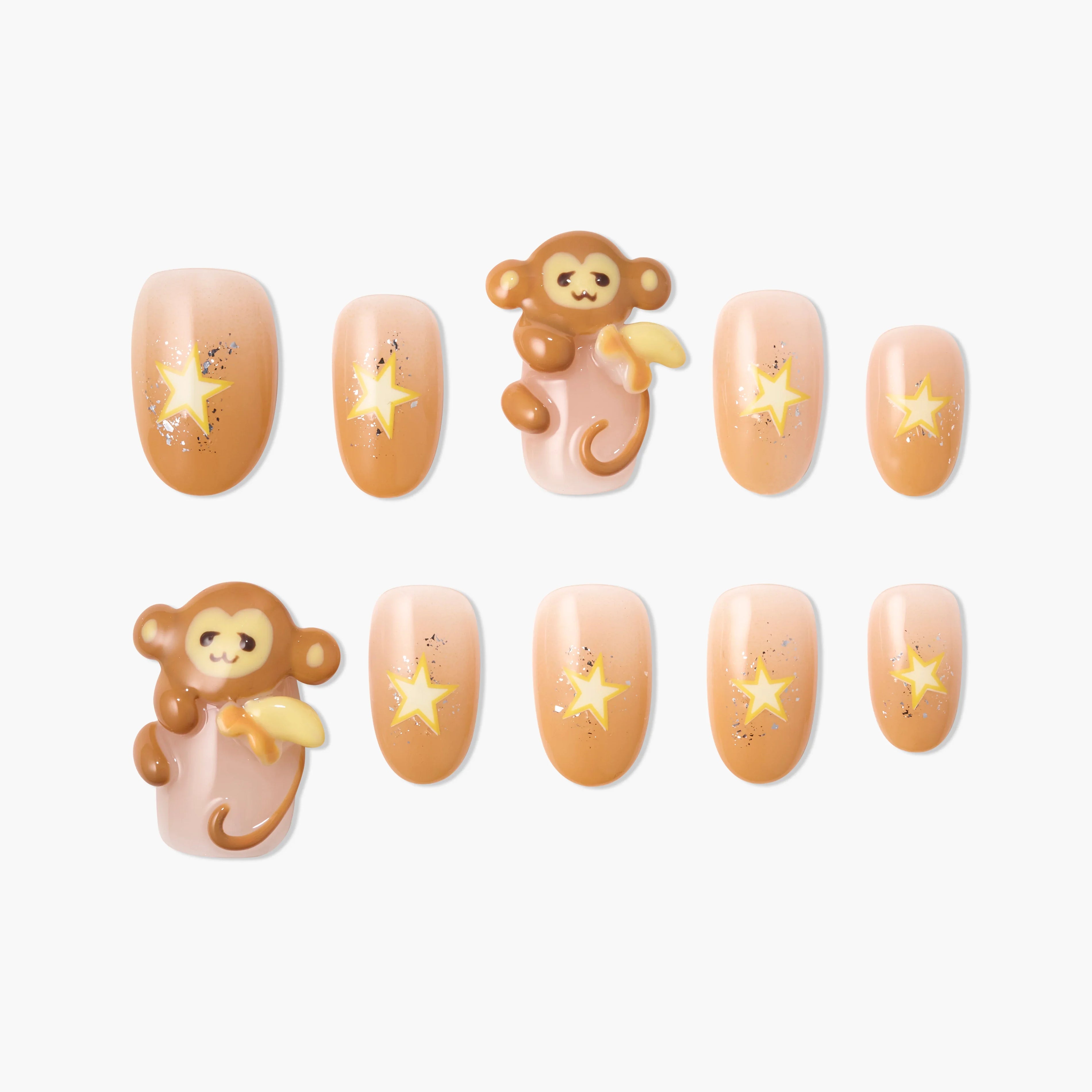 Cute press-on nails with playful monkey and yellow star designs, peach and nude tones