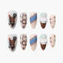 Handmade press-on nails with leopard print, metallic charms, denim accents, and cat face designs