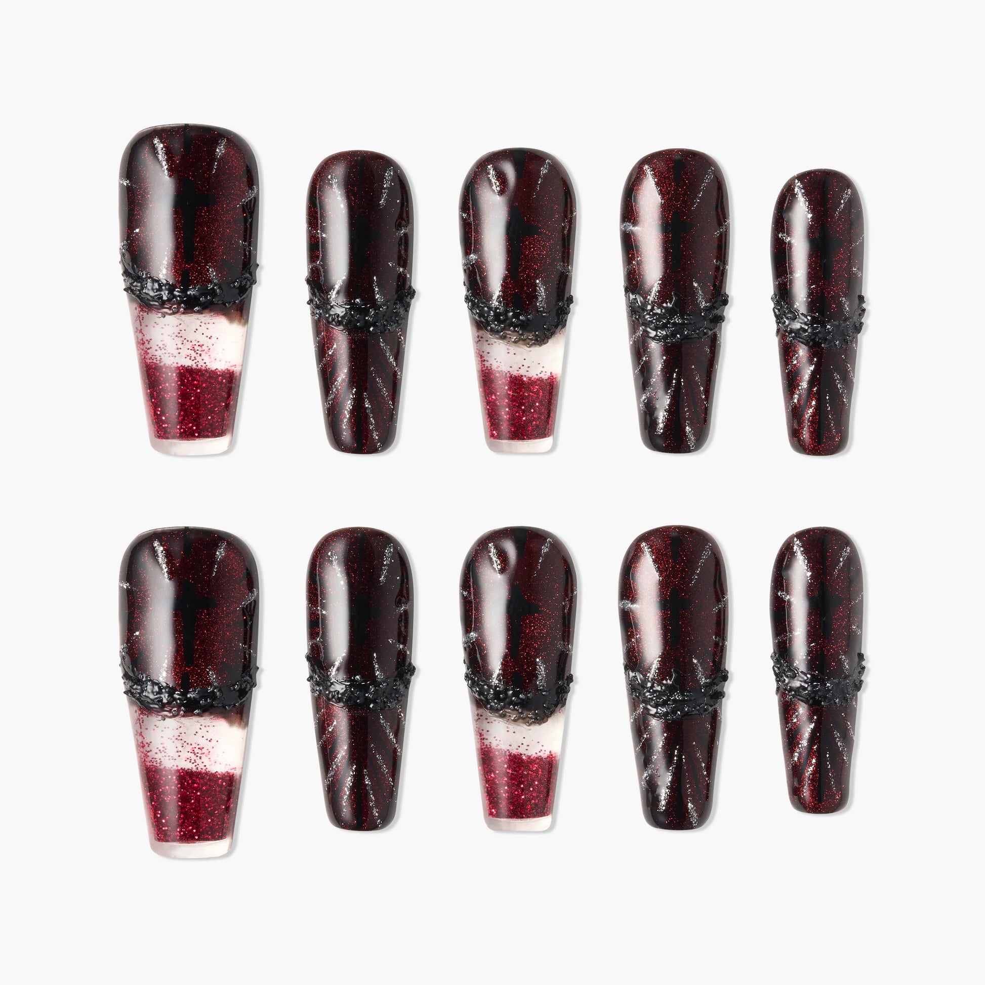 Glossy red and black press-on nails with glitter and black textured accents, arranged in two rows.