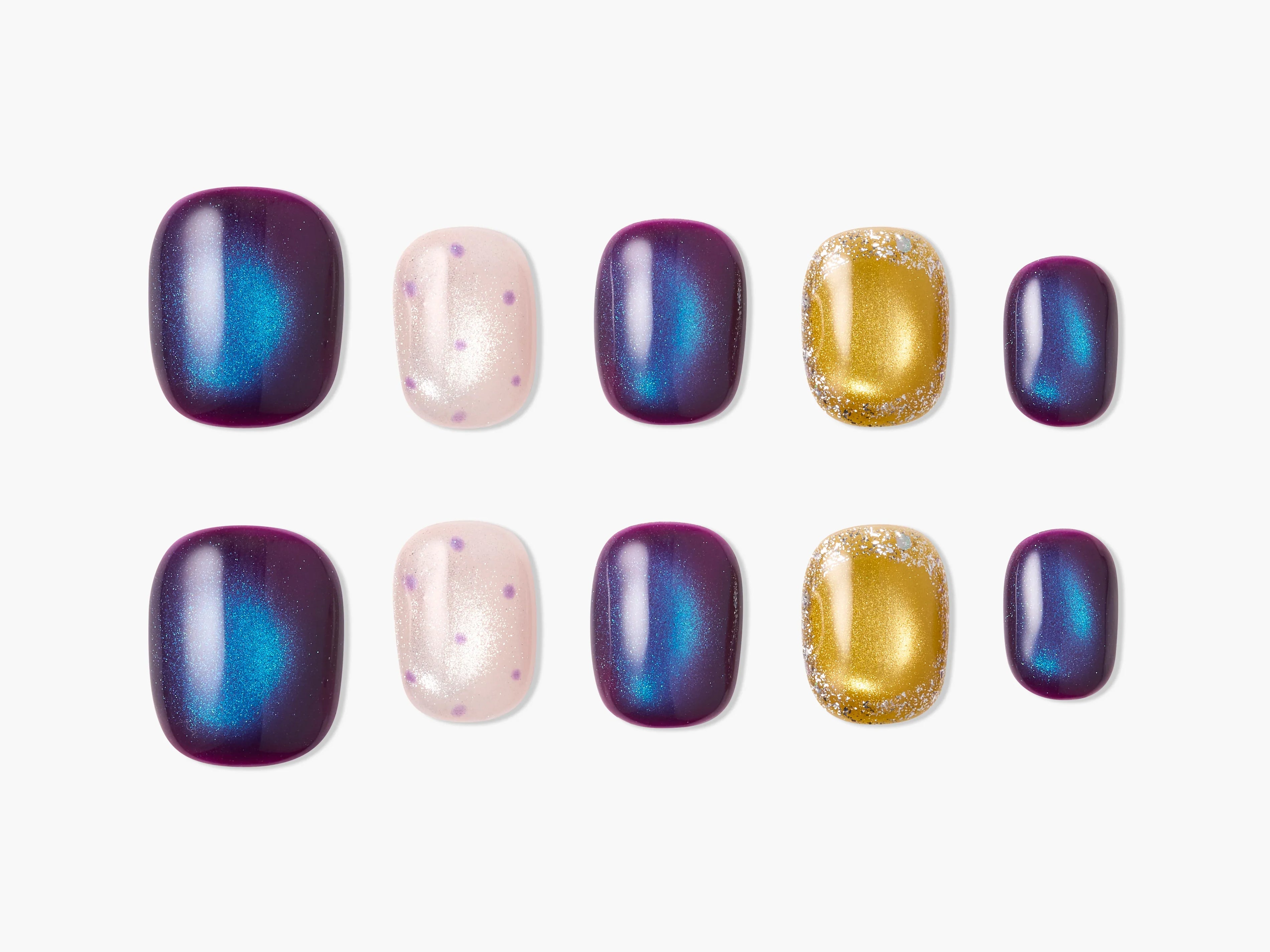 Handmade press-on nails in purple, blue, gold glitter, and pink with polka dot designs