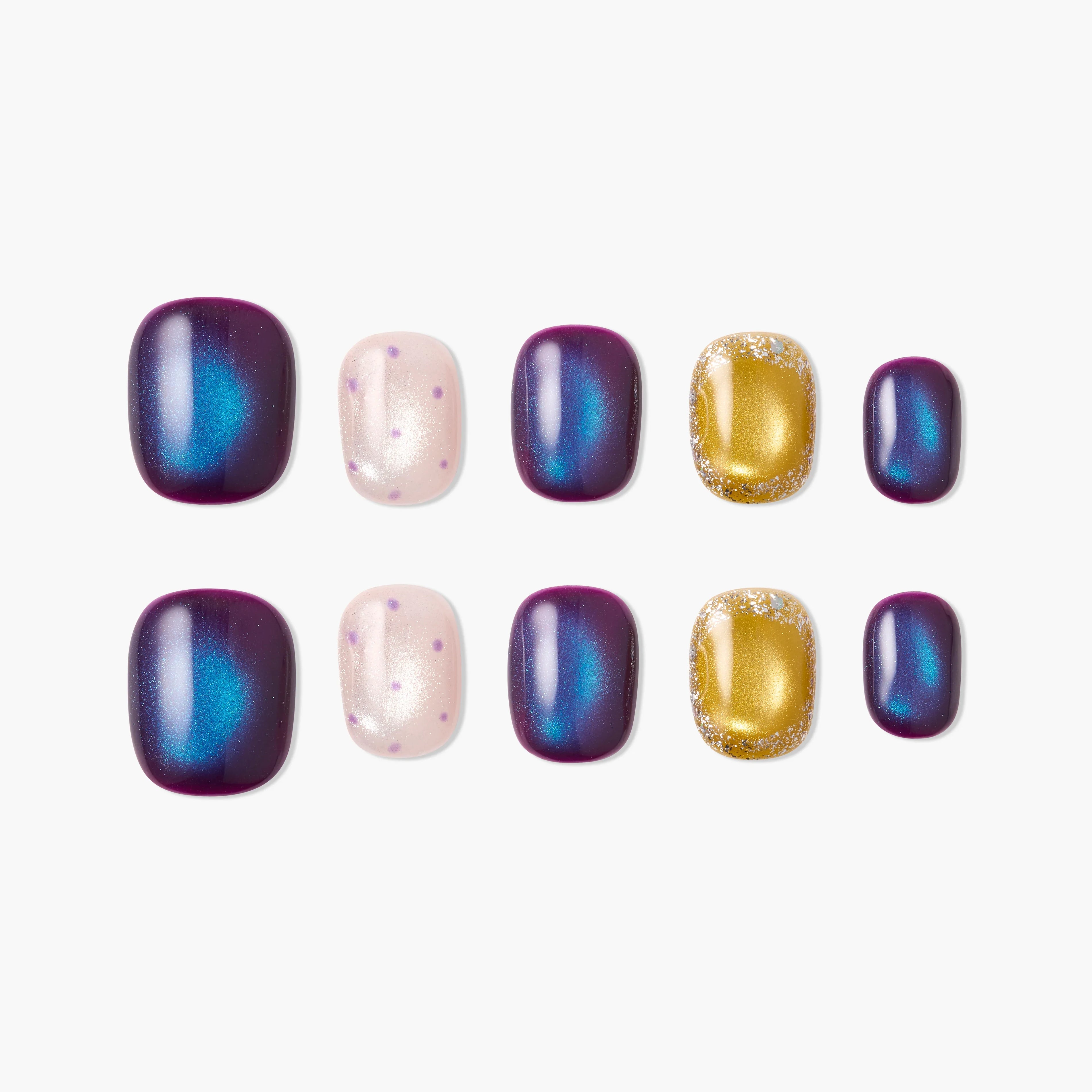 Handmade press-on nails in purple, blue, gold glitter, and pink with polka dot designs