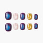 Handmade press-on nails in purple, blue, gold glitter, and pink with polka dot designs