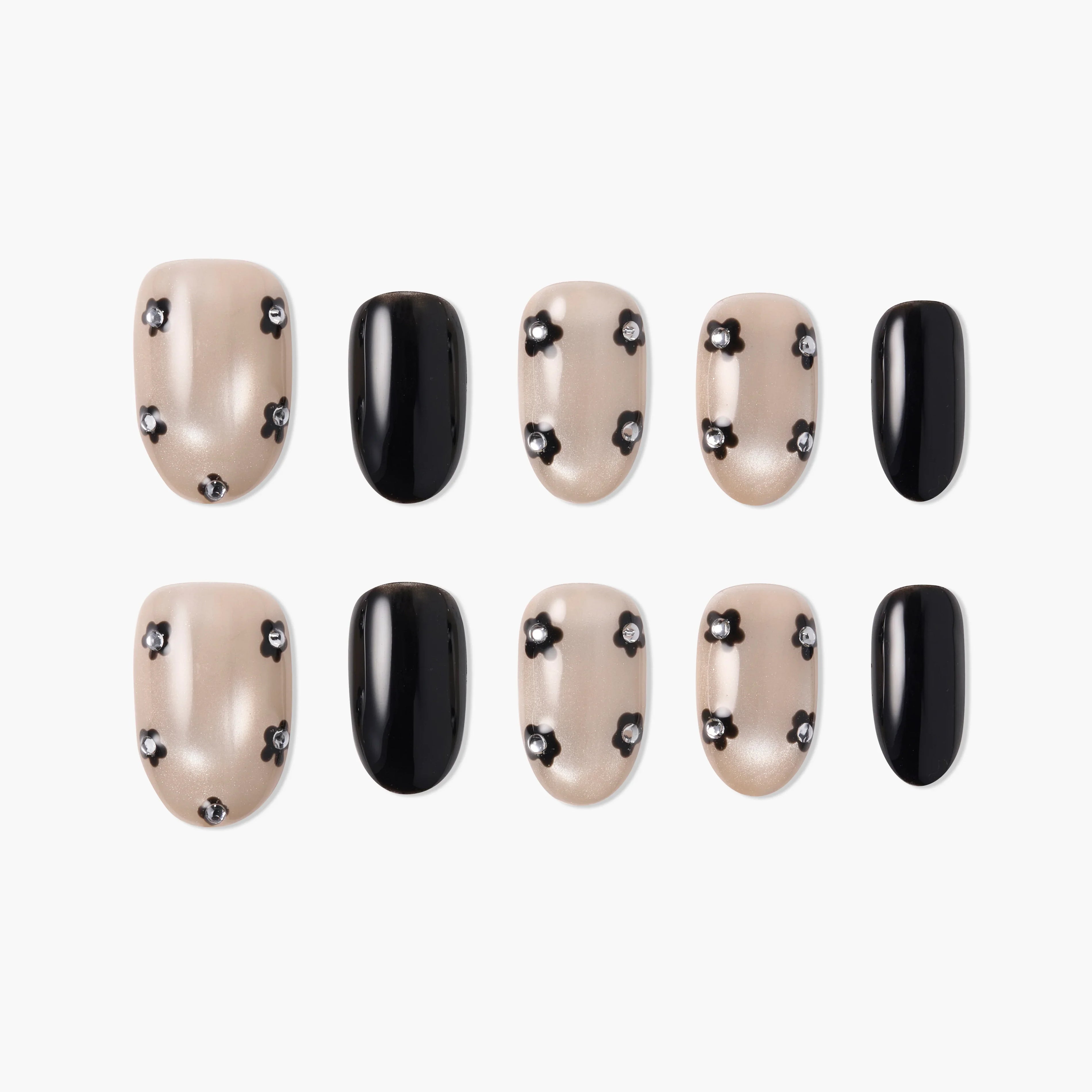 Handmade press-on nails set with pearl nude base, black floral accents, and solid black nails