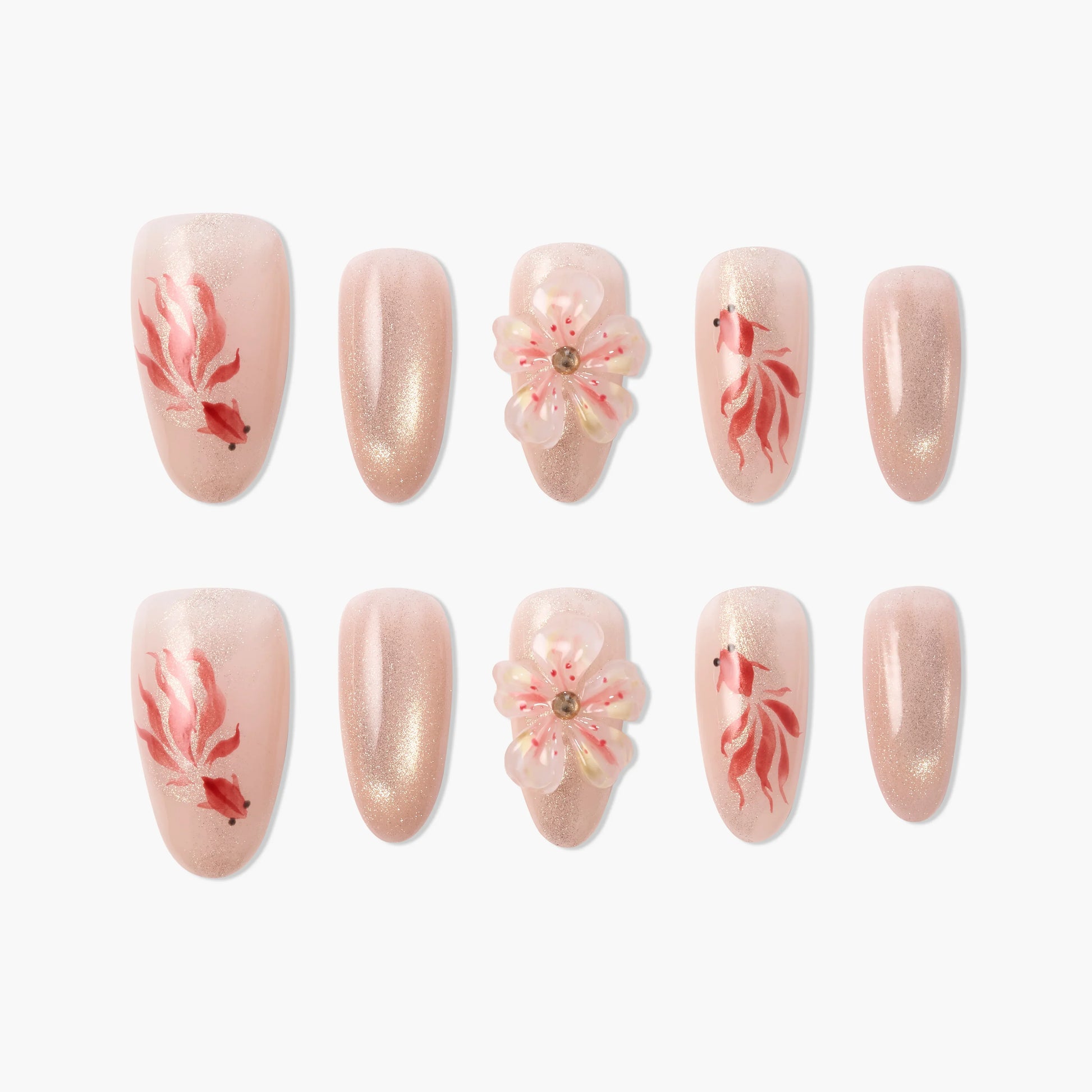 Handmade pink press-on nails with goldfish, glitter, and 3D floral designs arranged on white background
