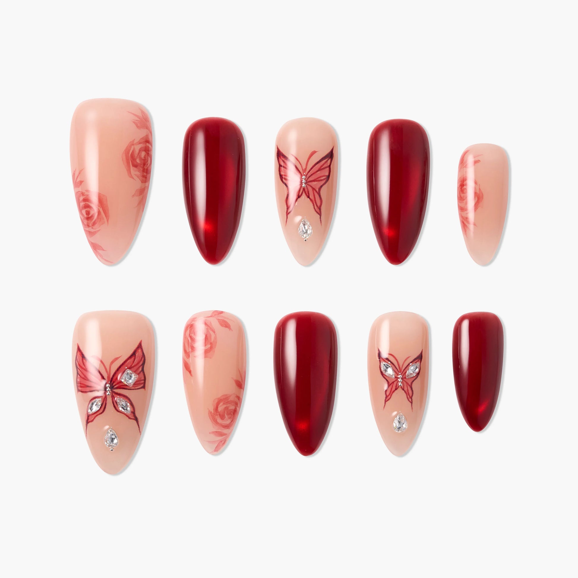 Handmade press-on nails with red butterfly, rose designs, and rhinestone accents on nude base.