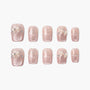 Handmade pink press-on nails with glitter, pearl bows, and rhinestone accents