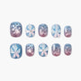 Handmade press-on nails with blue and purple ombre, 3D flowers, pearls, and polka dots