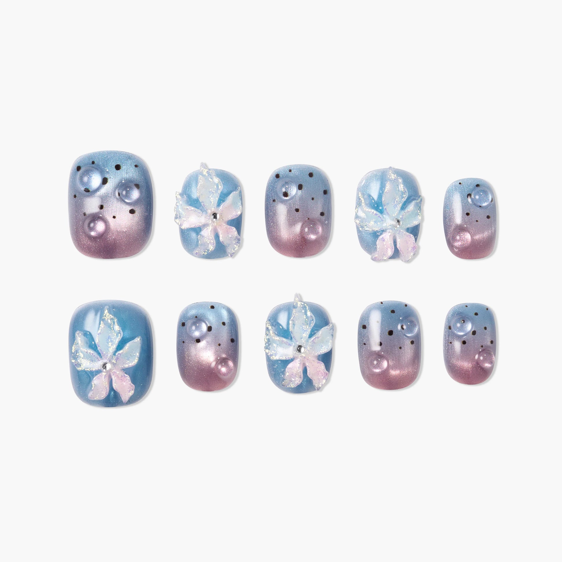 Handmade press-on nails with blue and purple ombre, 3D flowers, pearls, and polka dots