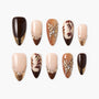 Handmade press-on nails with brown, gold, and nude designs, gems, and leaf art accents