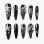 Black press-on nails with silver 3D stars, flowers, pearls, and glitter accents, arranged on a white background.