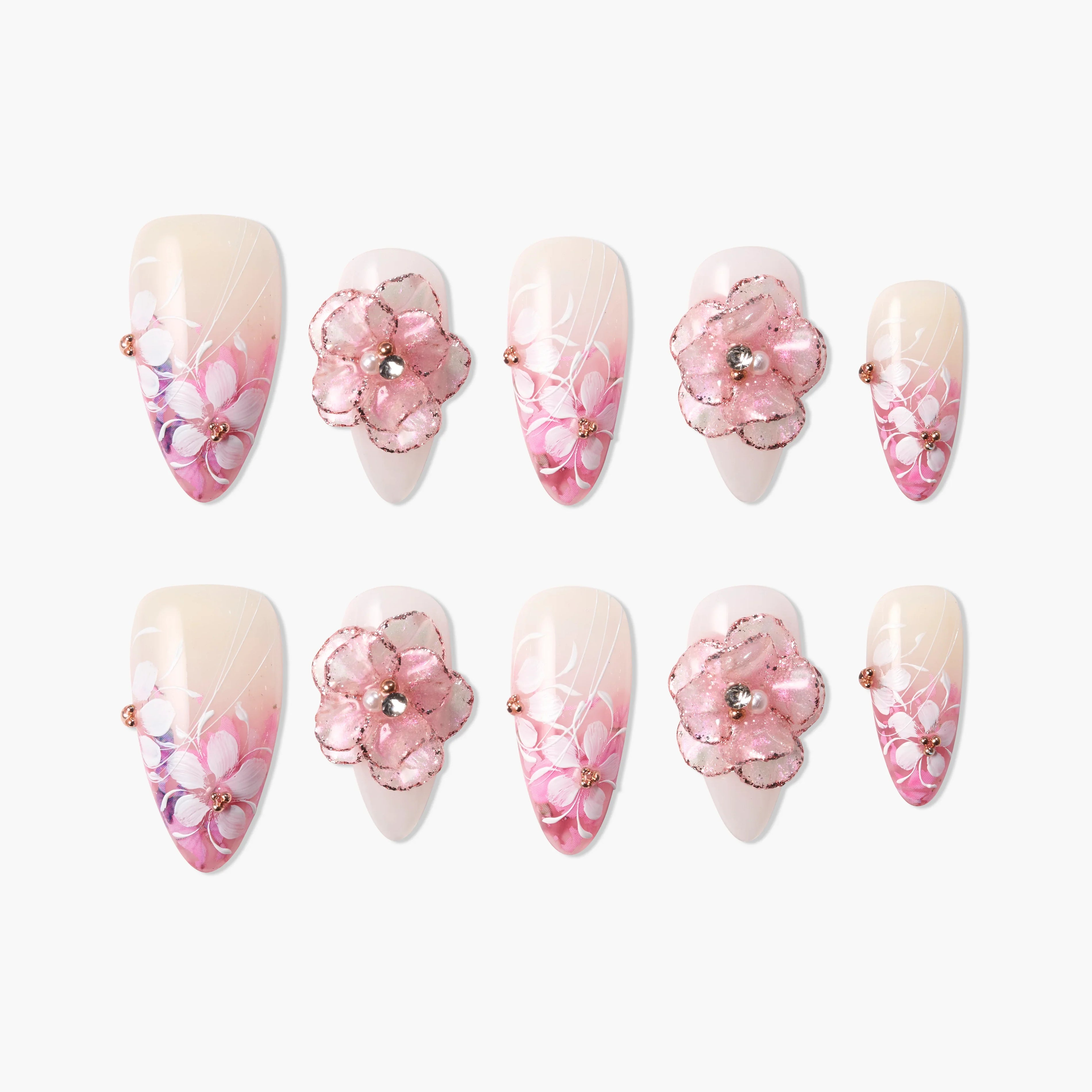 Pink floral press-on nails with 3D flower accents, gradient tips, and sparkling rhinestones.