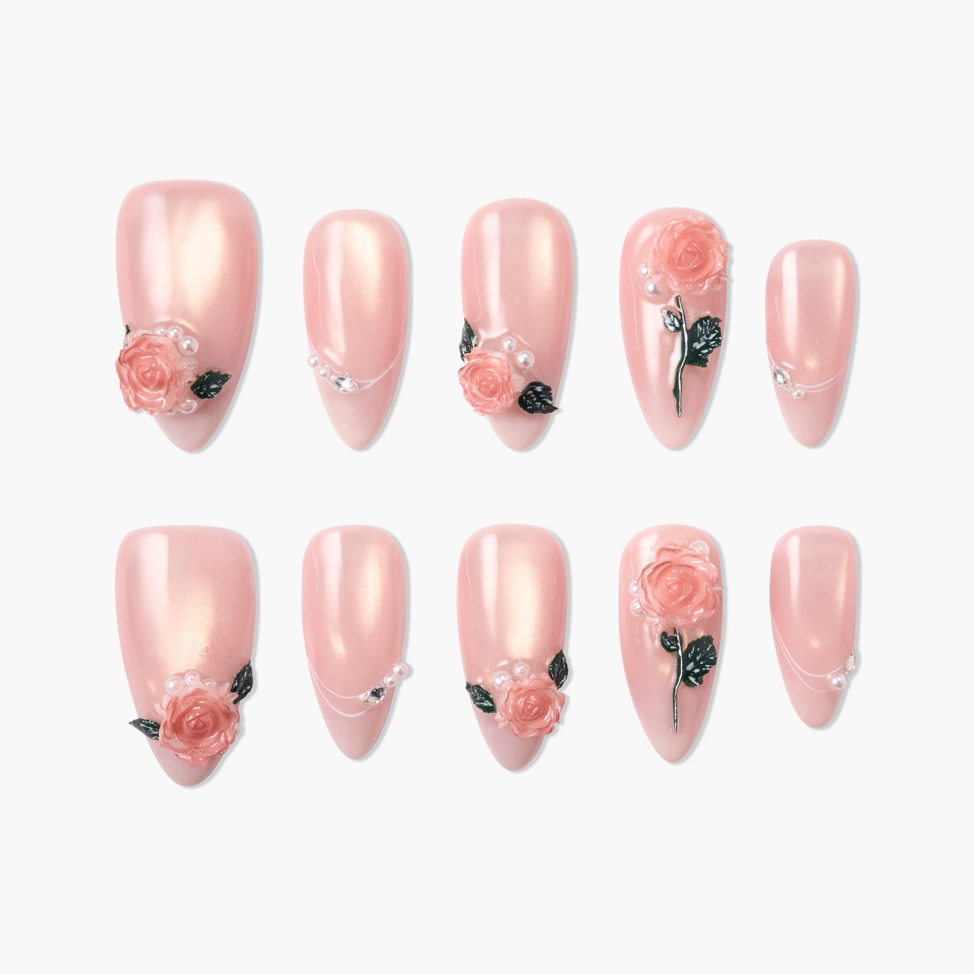 Handmade pink press-on nails with 3D rose flower and pearl designs, arranged on a white background.