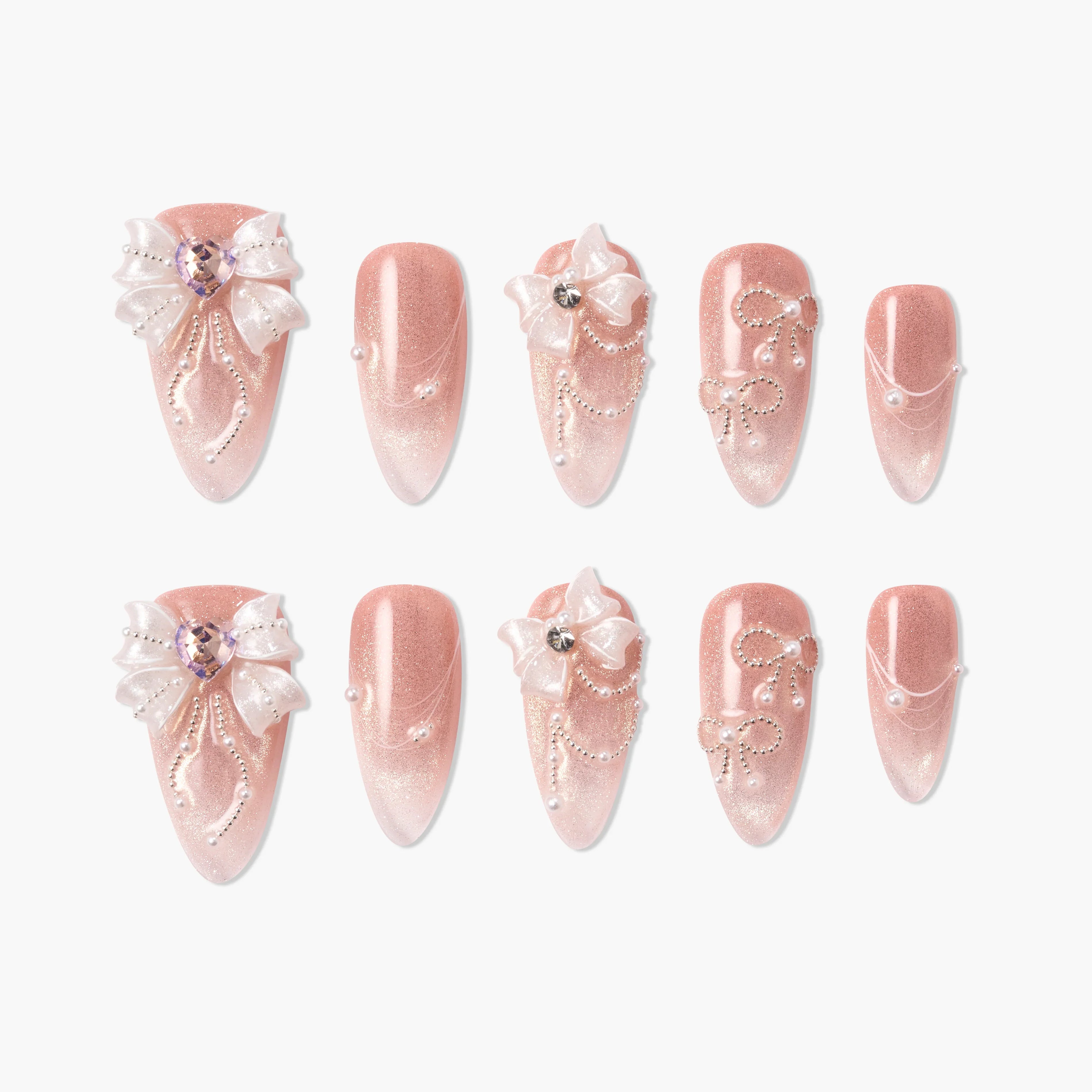 Pink ombre press-on nails with 3D bows, rhinestones, pearls, and elegant nail art