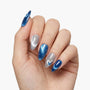 Hand with almond-shaped press-on nails in metallic blue and silver gradient design