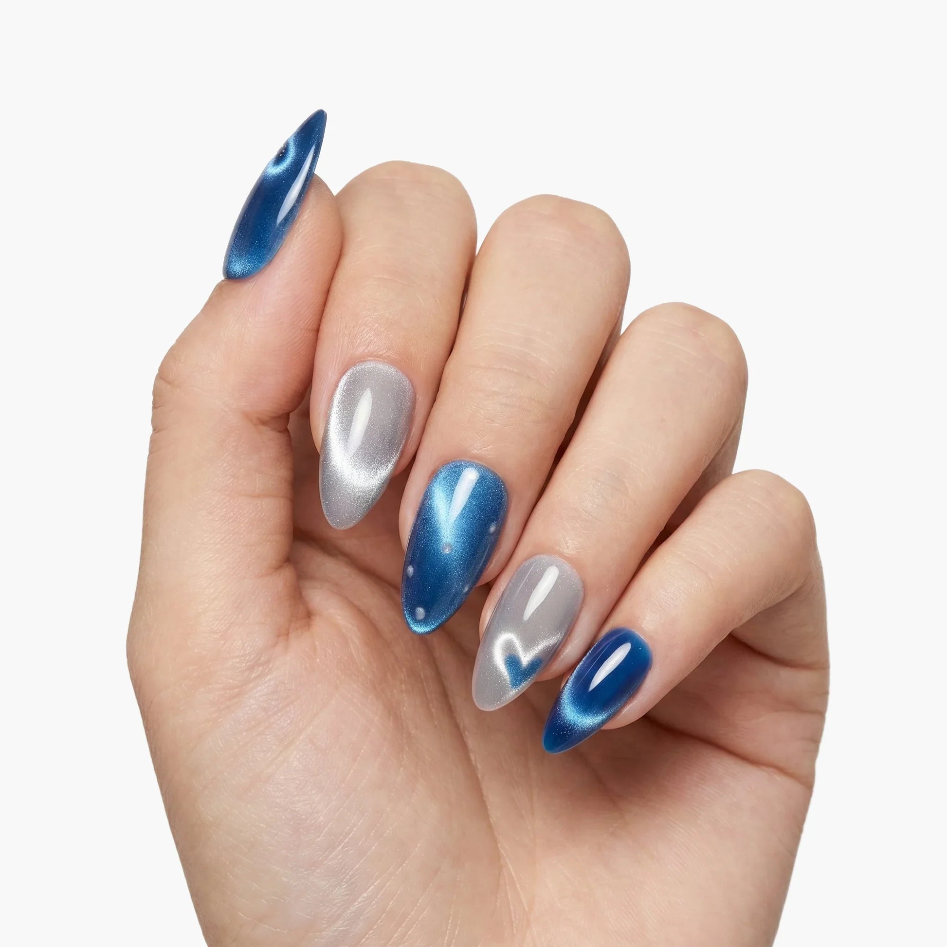 Hand with almond-shaped press-on nails in metallic blue and silver gradient design