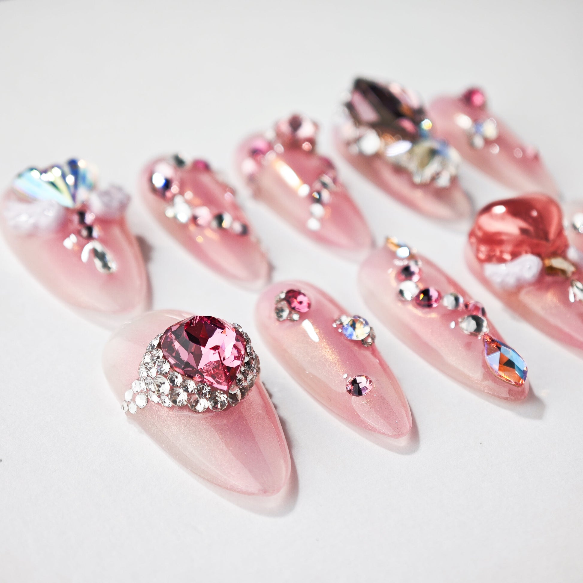Handmade pink press-on nails with 3D gems, rhinestones, and crystal embellishments