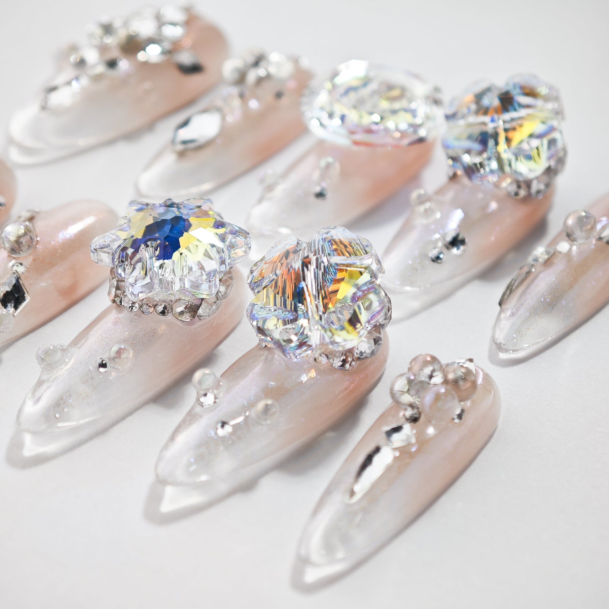 Handmade press-on nails with iridescent crystals and 3D rhinestone embellishments