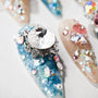 Handmade press-on nails with blue, pink, and crystal 3D rhinestone decorations