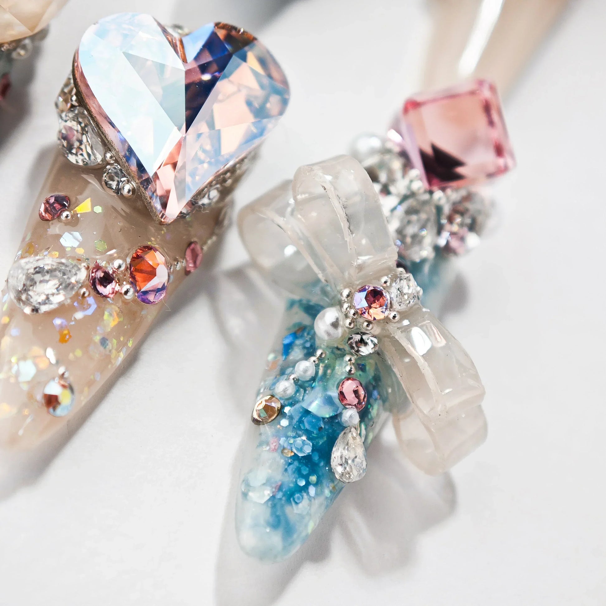 Handmade press-on nails with 3D heart gem, bow, and sparkling rhinestone accents