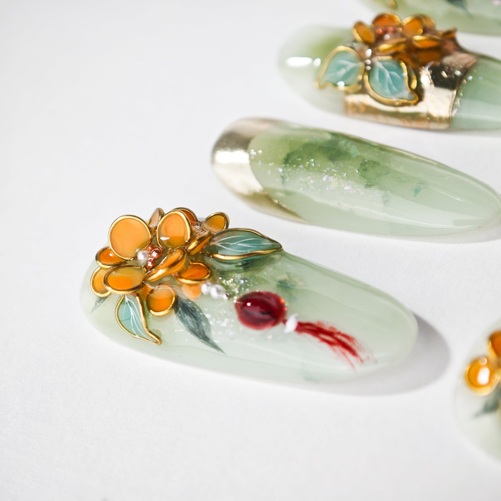 Handmade green press-on nails with gold floral and gemstone 3D nail art