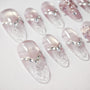 Handmade press-on nails with clear pink ombré design and crystal rhinestone accents