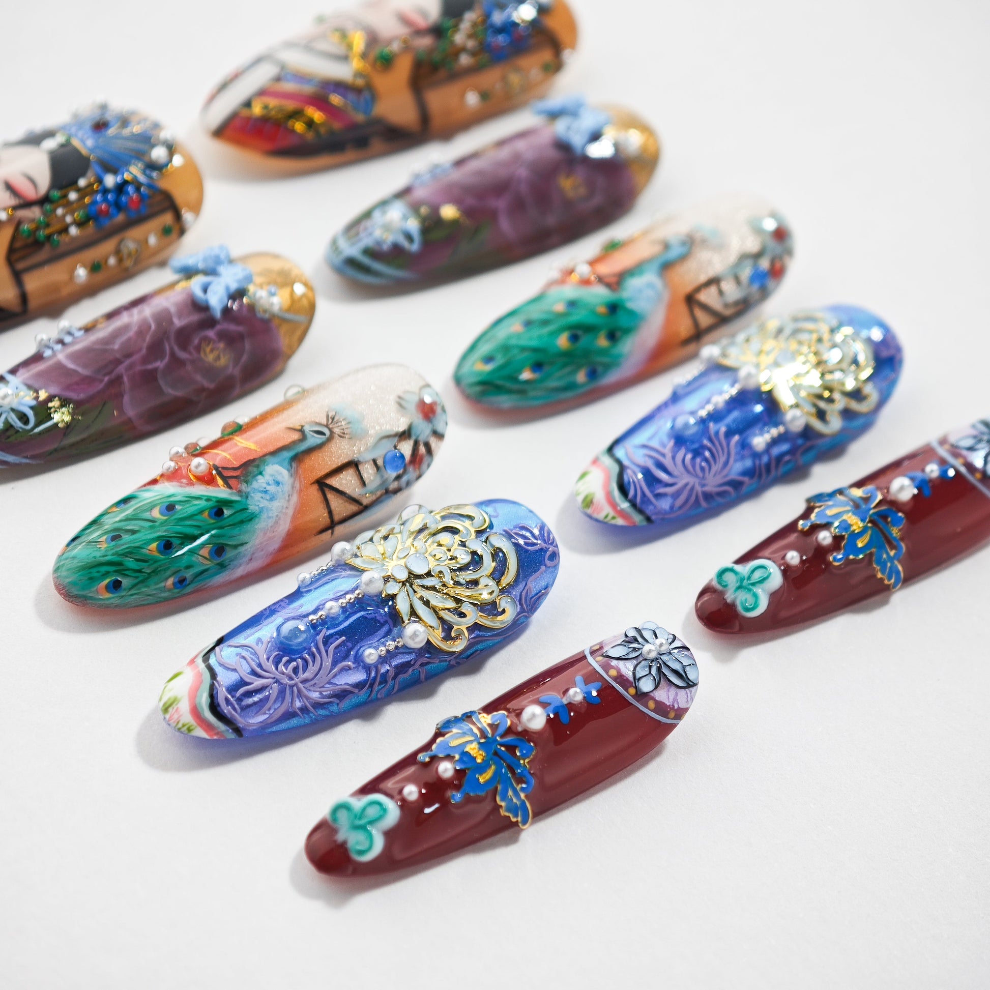 Handmade press-on nails with intricate 3D art, peacock, floral, and gemstone designs