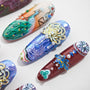Handmade press-on nails with detailed peacock and floral 3D nail art designs