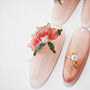 Handmade press-on nails with 3D pink floral and pearl designs on glossy nude base