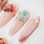 Handmade press-on nails with pink and blue butterfly, flower, pearl, and glitter accents