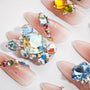Handmade press-on nails with nude base and colorful crystal rhinestone accents