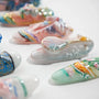 Handmade press-on nails with intricate floral and 3D designs on a white background.