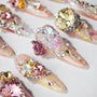 Handmade press-on nails with 3D floral designs, rhinestones, and colorful crystals.