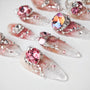 Handmade press-on nails with pink and silver rhinestones, large gems, and glitter accents
