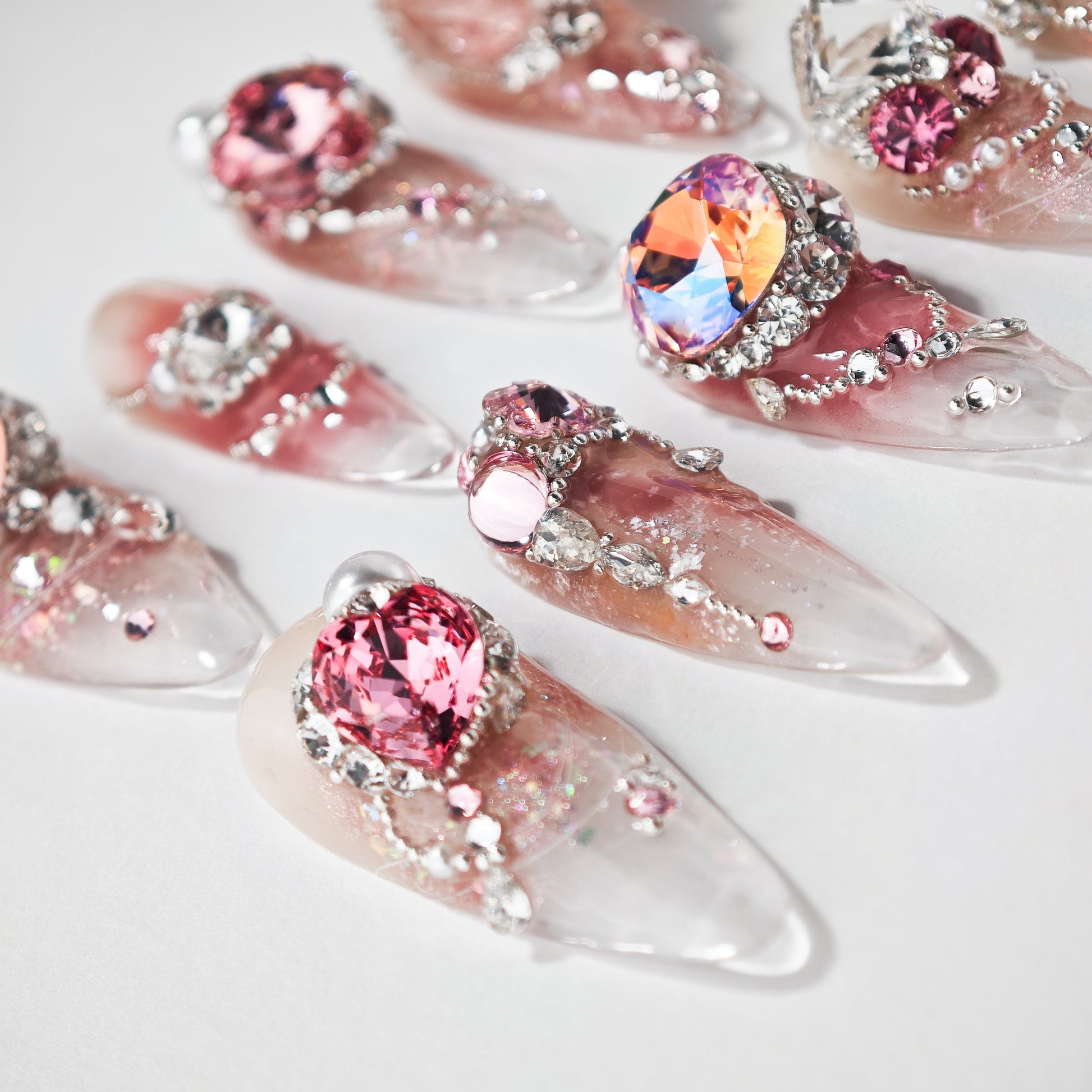 Handmade press-on nails with pink and silver rhinestones, large gems, and glitter accents