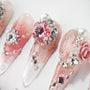 Handmade pink press-on nails with rhinestones, crystals, pearls, and 3D floral accents