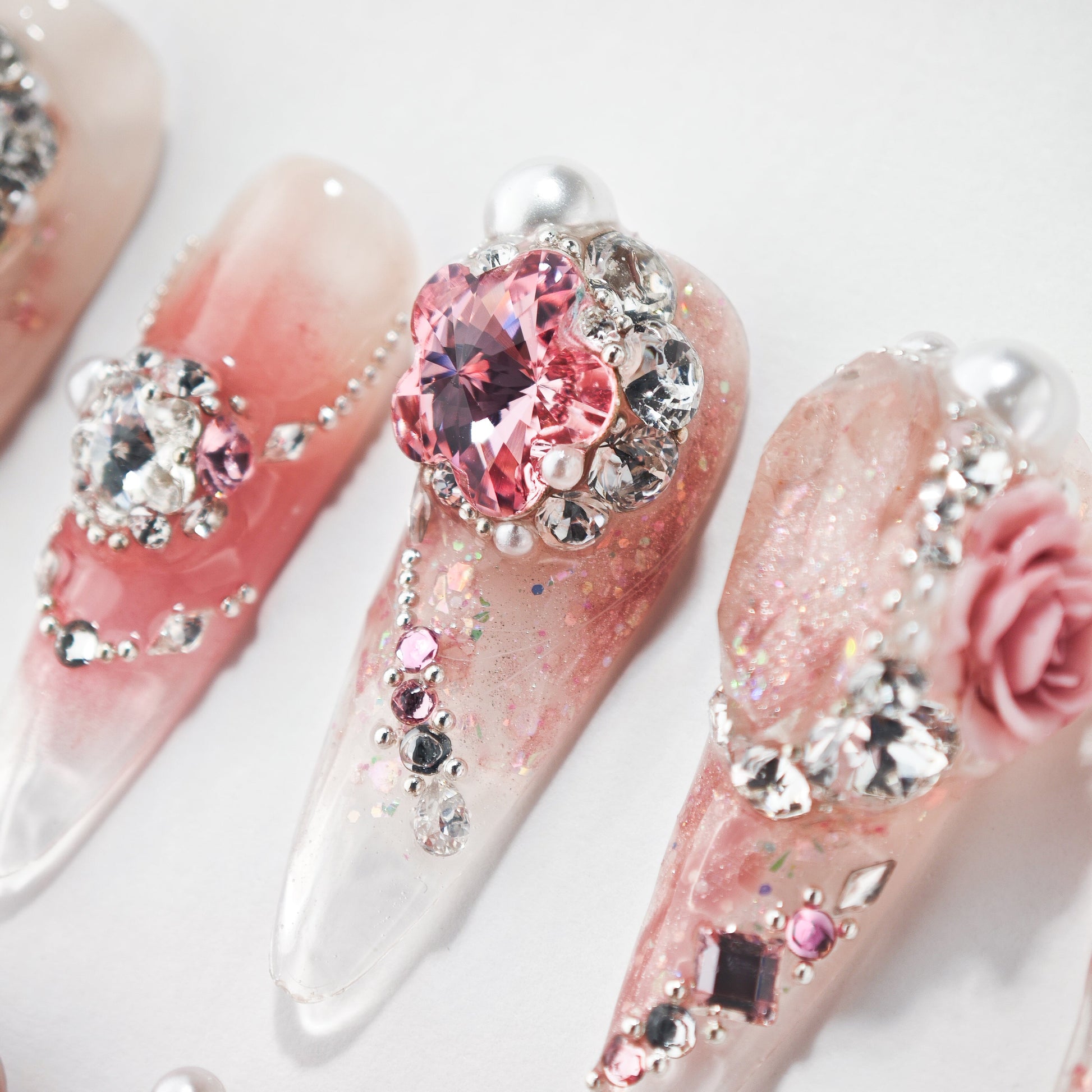 Handmade pink press-on nails with rhinestones, crystals, pearls, and 3D floral accents