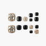 Set of black and glitter press-on toenails with silver rhinestone accents on a white background